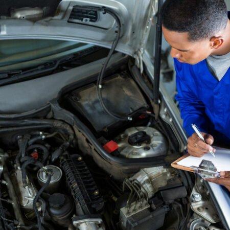 Mechanic preparing a check list at repair garage