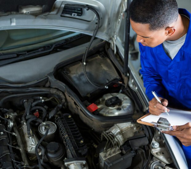 Mechanic preparing a check list at repair garage