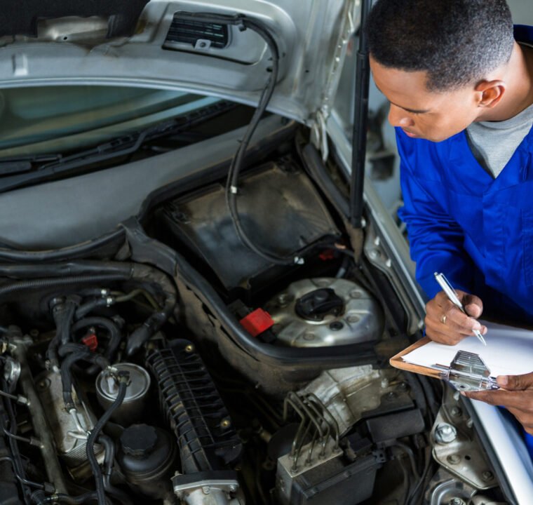 Mechanic preparing a check list at repair garage